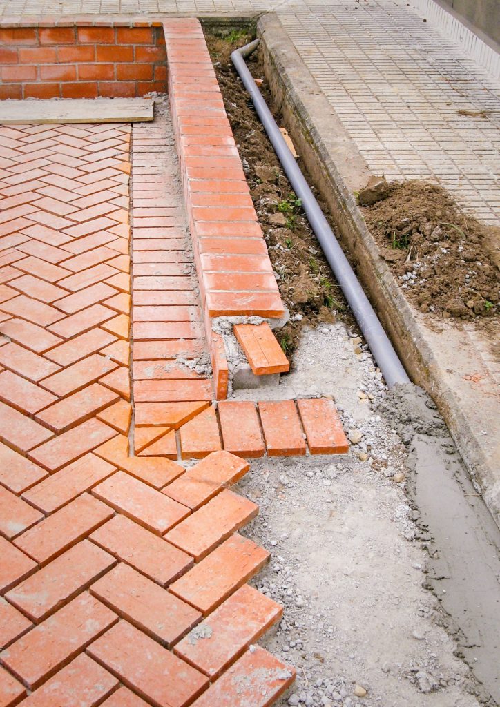 Orange brick paving stones in construction process