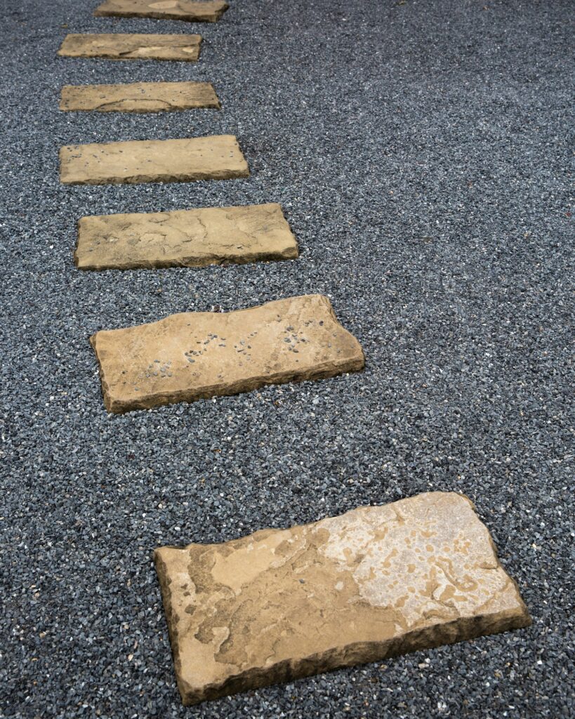 The Stone walk path in the asian park with grey small stones on background
